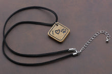 Load image into Gallery viewer, Henry &amp; Sadie Canary Wood Necklace with Leather necklace.  The wood pendant has I heart paw on it. 