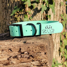 Load image into Gallery viewer, Henry &amp; Sadie Sea Foam Green Collar with Black Hardware sitting on a log with a tree and green leaves in the background. Picture provided by Britney Muth