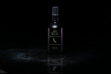 Load image into Gallery viewer, A dark matte spray bottle with white lettering reading 'Crème de Lavande' and 'Room and Linen Spray' stands centered against a black background on a reflective dark surface.