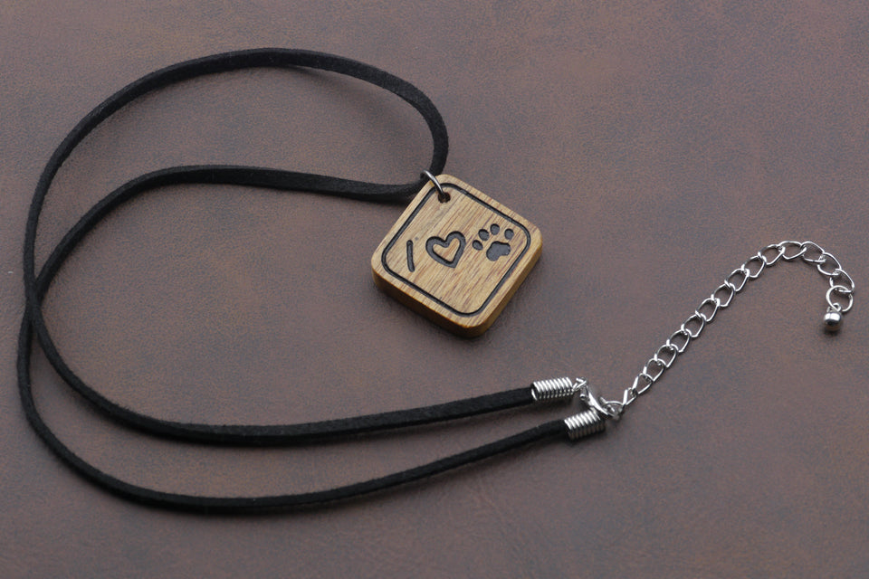 Henry & Sadie Canary Wood Necklace with Leather necklace.  The wood pendant has I heart paw on it. 
