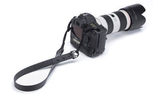 Load image into Gallery viewer, Henry &amp; Sadie 1 inch Onyx Black Camera Strap connected to a camera and lens