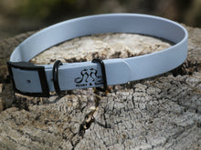 Load image into Gallery viewer, Henry &amp; Sadie Stormy Blue Collar with a Traditional Black Buckle and Black Hardware with logo on a gray tree stump